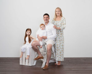 family of parents and two children wearing white photographed by Family photographer Lancashire