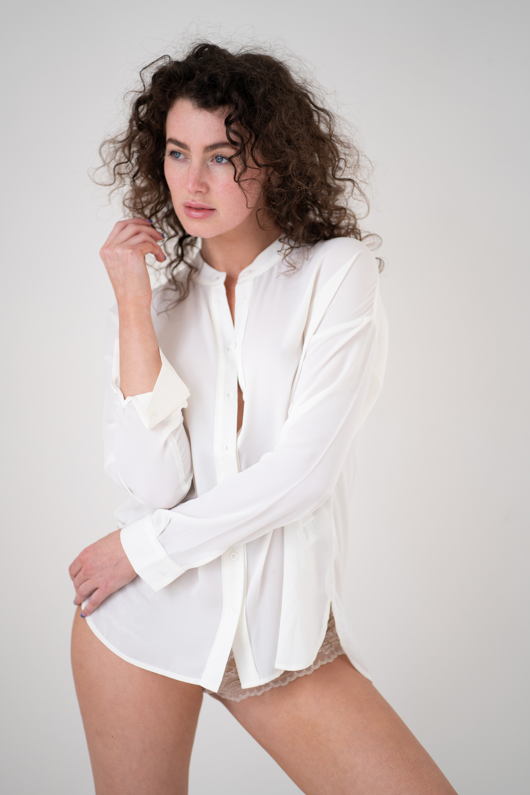 brunette on white background in white shirt by Boudoir Photographer Lancashire