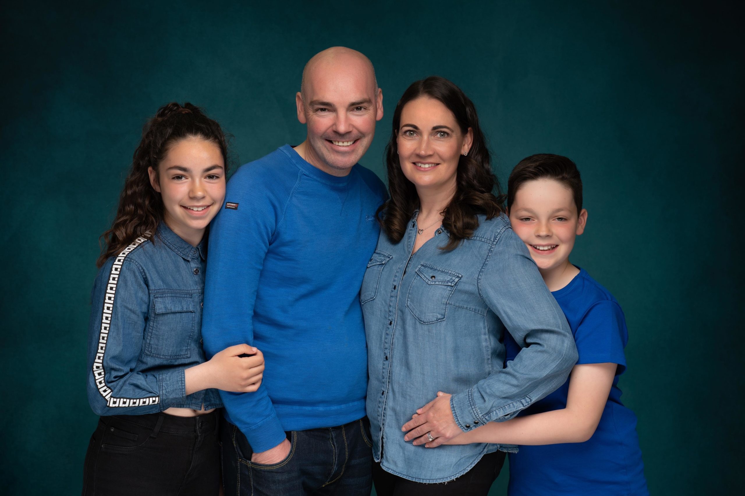 family with kids dressed in blue photographed by family photographer in preston lancashire