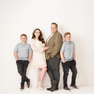 family of four in photography studio on white background by Family photographer in preston lancashire